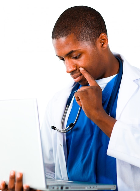 Thoughtful doctor working with a computer