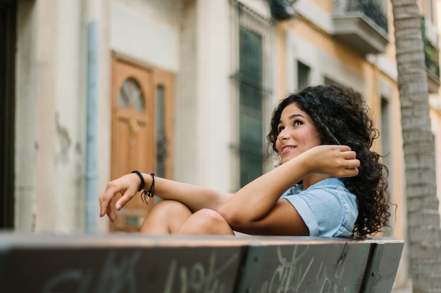 Thoughtful girl sitting on a bench