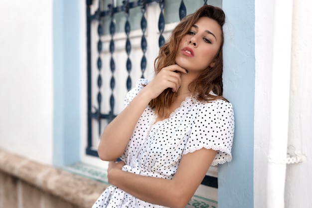 Thoughtful girl next to a window