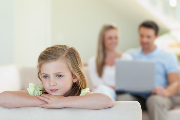 Thoughtful girl with parents behind her