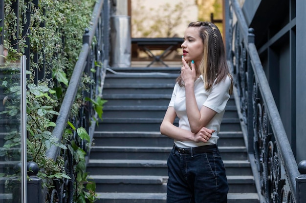 Thoughtful lady stand on stairs and thinking