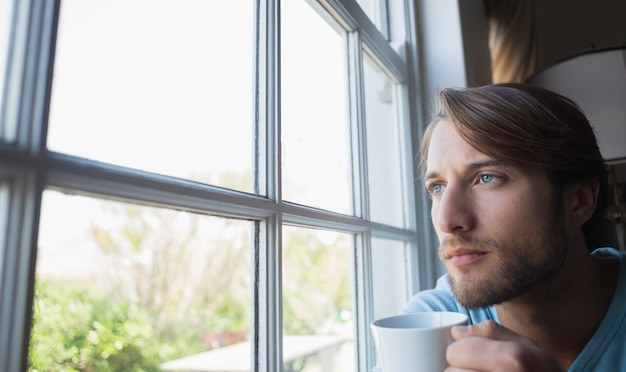 Photo thoughtful man looking out the window