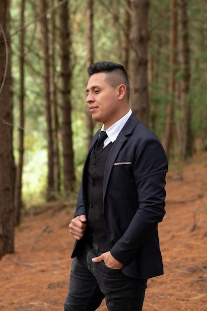 Thoughtful man in nature surrounded by logs