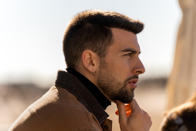 Thoughtful man touching chin on street