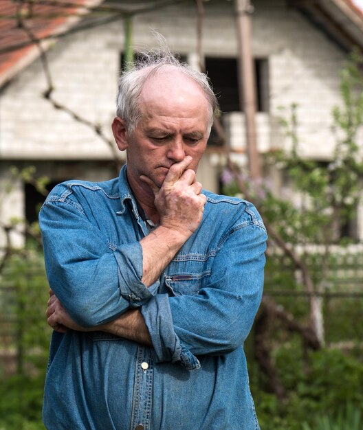 Thoughtful senior man in the garden