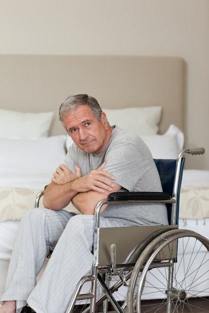 Thoughtful senior man in his wheelchair  