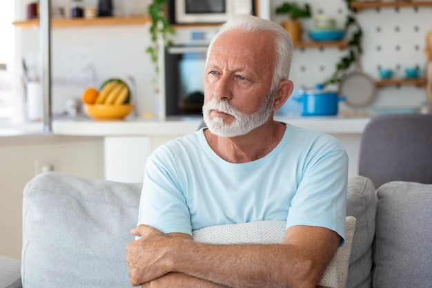 Thoughtful senior man relaxing at home Close up of a senior man contemplating