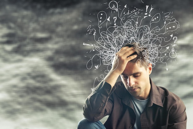 Thoughtful stressed young man with a mess