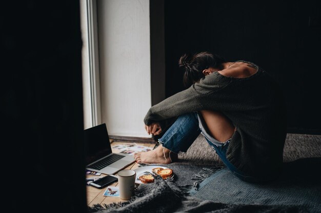 thoughtful woman siting at home