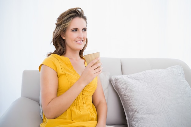 Thoughtful woman sitting on couch 