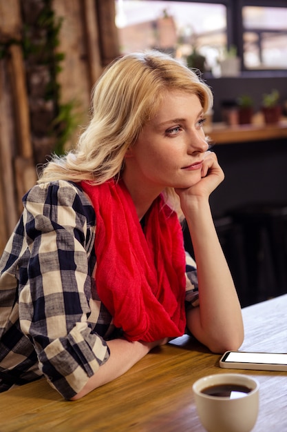 Thoughtful woman sitting at a table