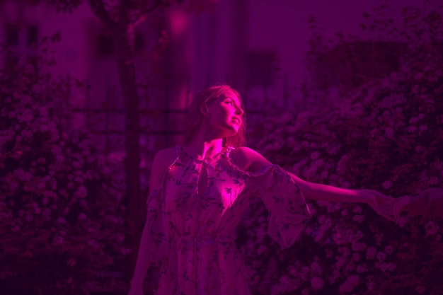 Thoughtful woman standing outdoors at night