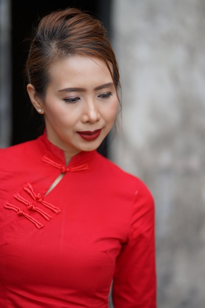 Thoughtful woman in traditional clothing standing outdoors