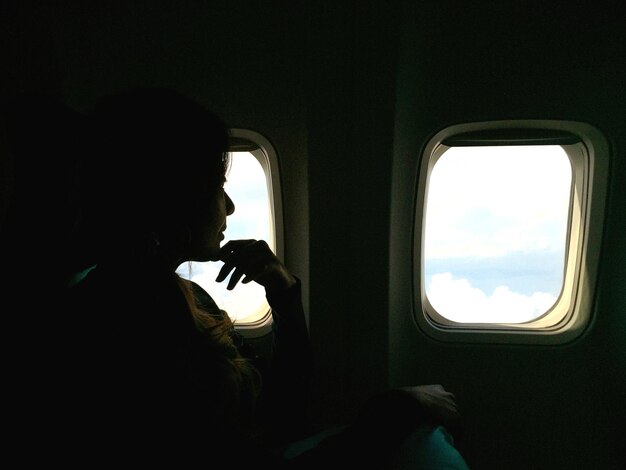 Thoughtful woman traveling in airplane