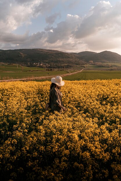  thoughtful woman walking among flowers in the countryside. Melancholy concept