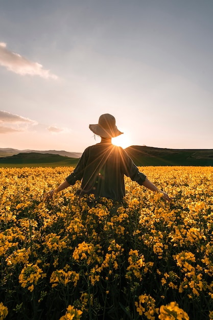  thoughtful woman walking among flowers in the countryside. Melancholy concept