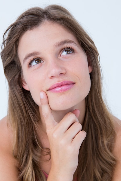 Thoughtful woman with finger on chin 