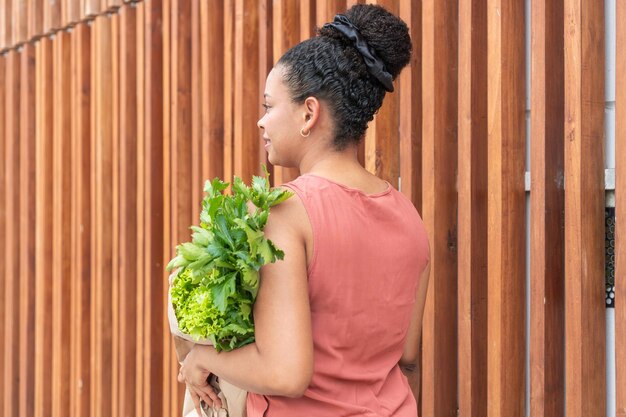 Photo thoughtful woman with grocery greens