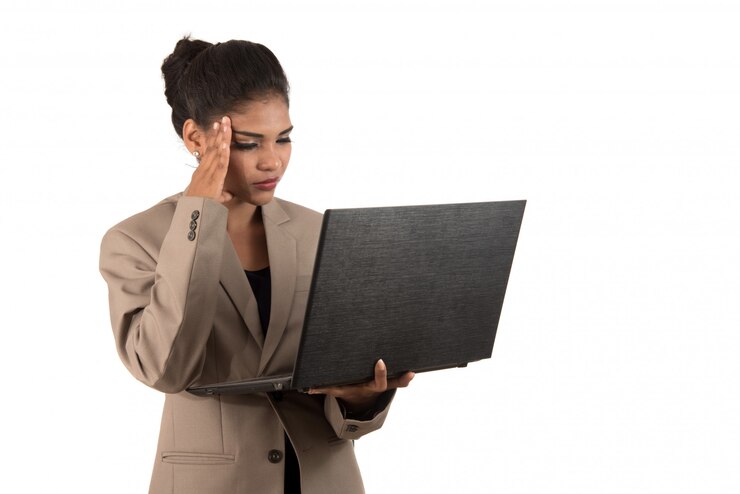 Thoughtful woman with a laptop - isolated over a white space