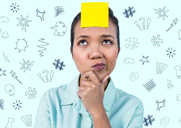 Thoughtful woman with sticky note on her forehead