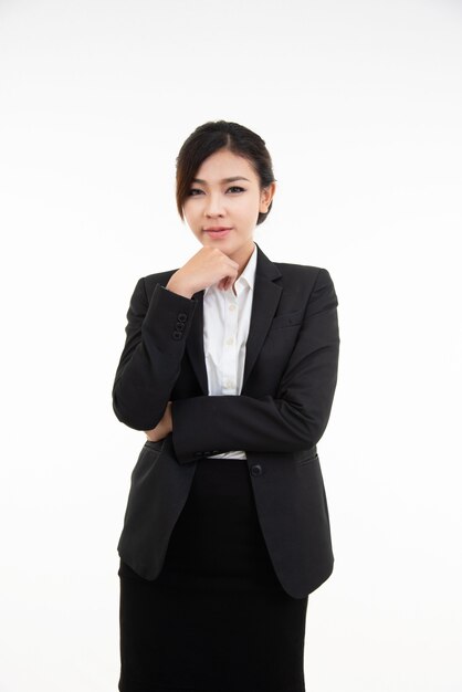 Thoughtful young asian businesswoman resting her chin on her hand and looking straight into the camera