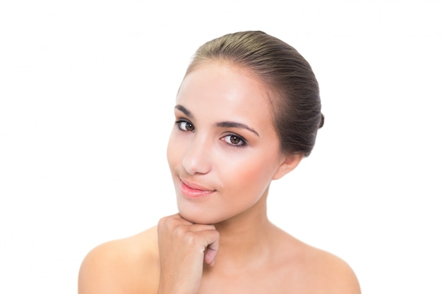 Thoughtful young brunette woman looking at camera