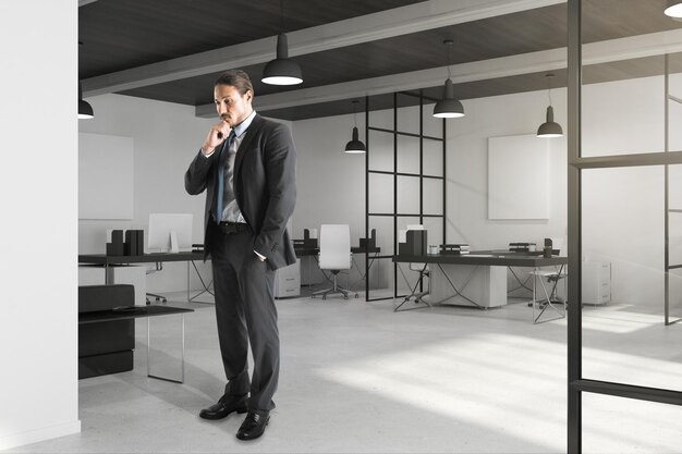 Thoughtful young businessman in office