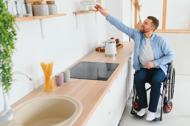 Thoughtful young disabled man on wheelchair at home