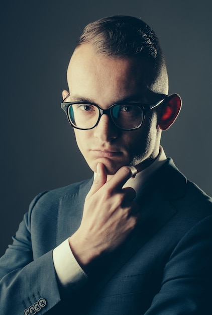 Thoughtful young guy in glasses