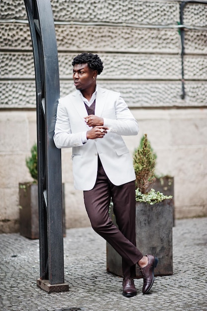 Thoughtful young handsome african american gentleman in formalwear Black stylish model man in white jacket