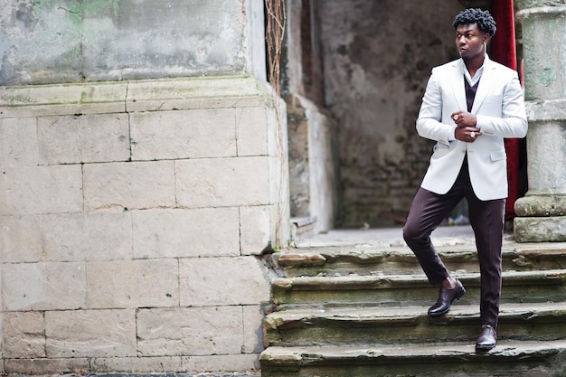 Thoughtful young handsome african american gentleman in formalwear Black stylish model man in white jacket