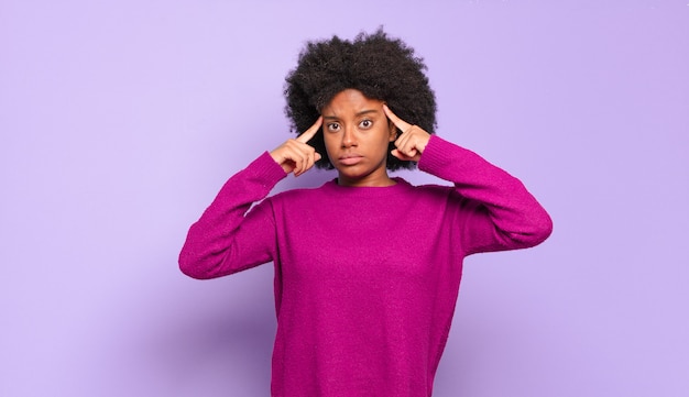 thoughtful young pretty black woman