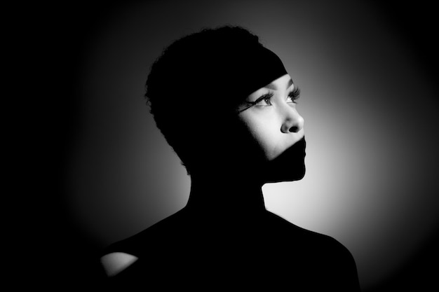 thoughtful young woman against gray background