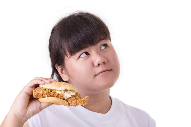 Photo thoughtful young woman holding burger against white background