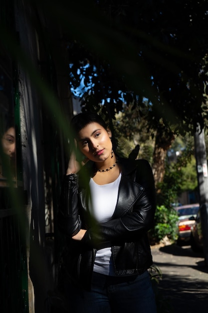 Thoughtful young woman standing against trees