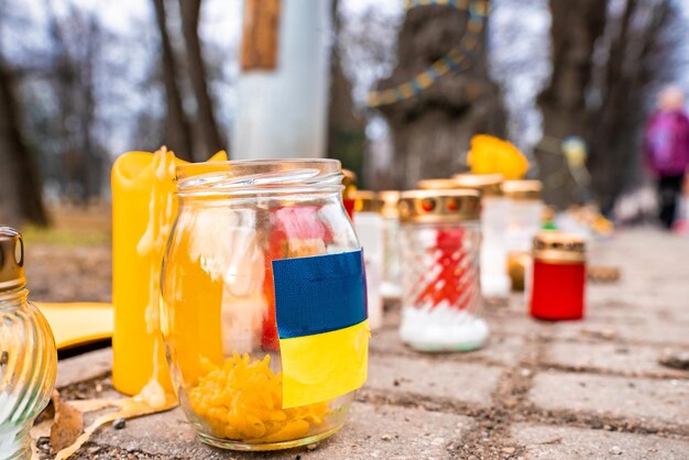 Thousands candles and flowers standing on the street during the war in ukraine