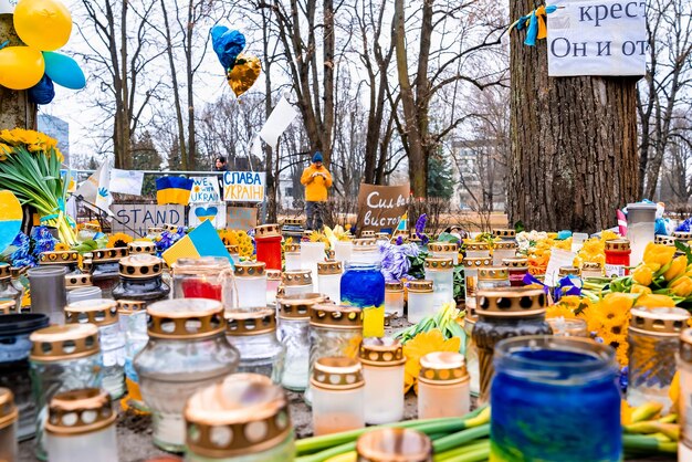 Thousands candles and flowers standing on the street during the war in ukraine