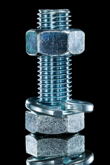 Threaded construction nut screwbolt spring washer on black surface