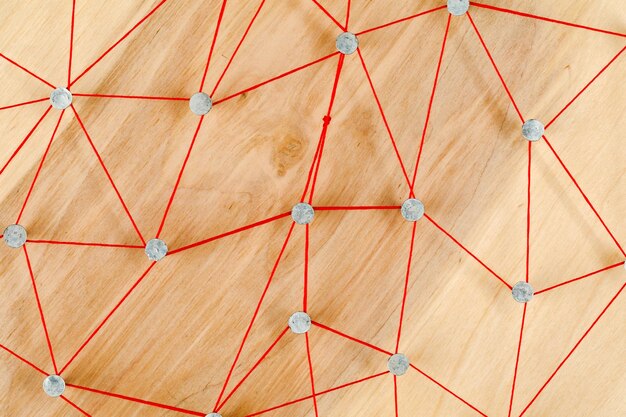 Threads and nails on a wooden board