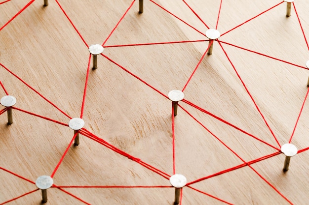 Threads and nails on a wooden board