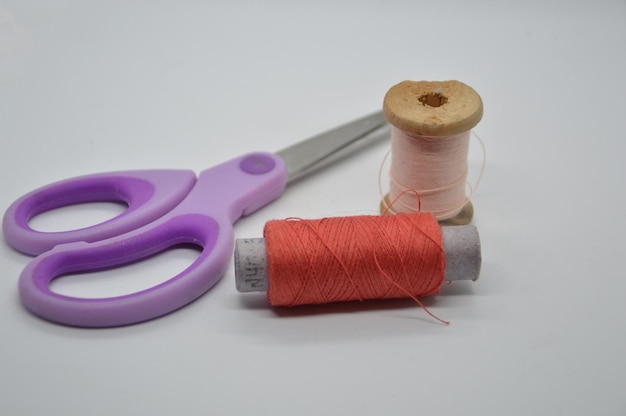 Threads and spools for sewing clothes on a white background