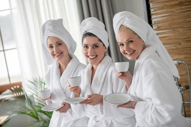 Three adorable adult girlfriends in spa