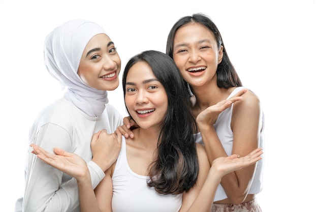 Three affectionate woman smiling with present something hands gesture