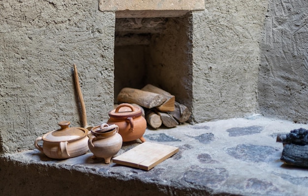 Three ancient clay pots on a cement floor