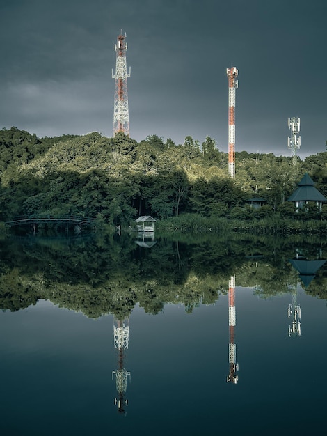 Three Antenna tower at the top of the lake with clear reflections and Clear sky