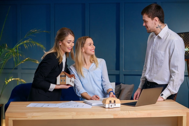 Three architects discussing design of new house, flat.