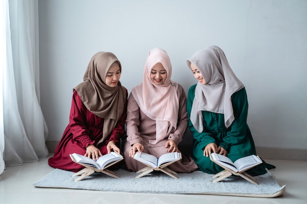 Three asian muslim woman read and learn the holy book of the Al-Quran together