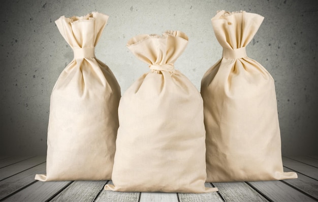 Three bags from a sacking on wooden background