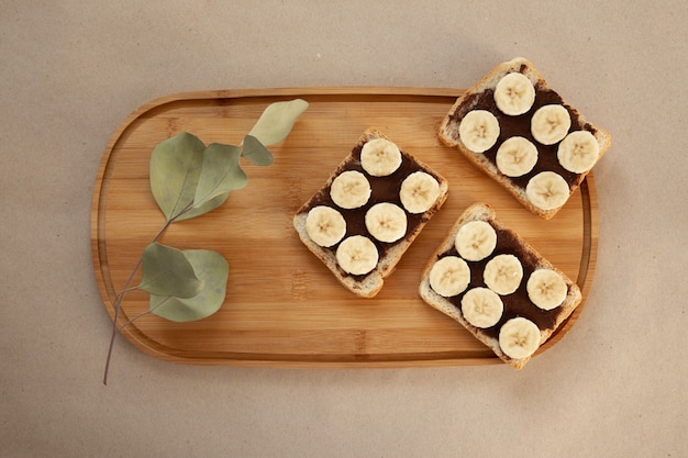 Photo three banana white bread toasts smeared with chocolate