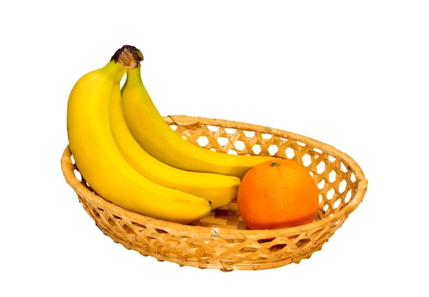 Three bananas and one orange in a wicker plate